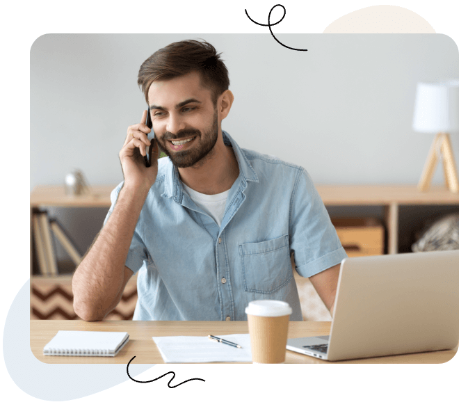 Guy on Phone in front of laptop